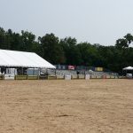 Large portable, rented bleachers alongside tents with sponsorship signs at a horse show in Ohio