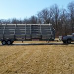 Medium sized portable bleachers compacted for transport and hitched on truck alongside fall Ohio landscape