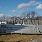 Fully extended portable bleacher setup with rails and two handrail dividers